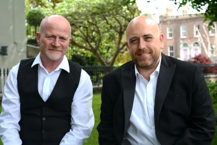 Jacob Law LLP solicitor partners Steven Jacob and Damian Woods seated outdoors in front of a Georgian building