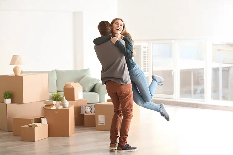 A happy couple moving into their new home after going sale agreed